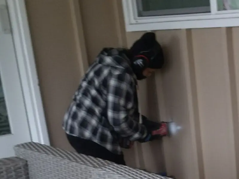 Professional electrician installing an exterior outlet in Leland