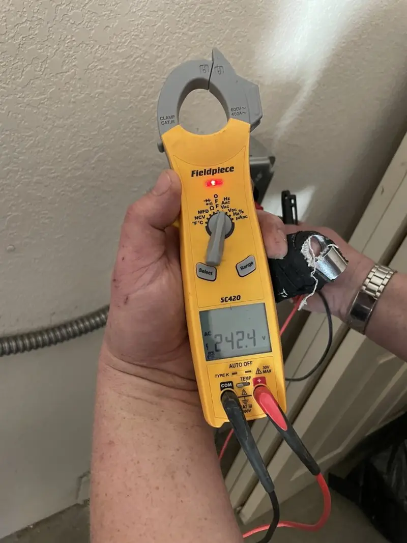 Voltage testing with clamp meter during Recessed Lighting Installation in Leland